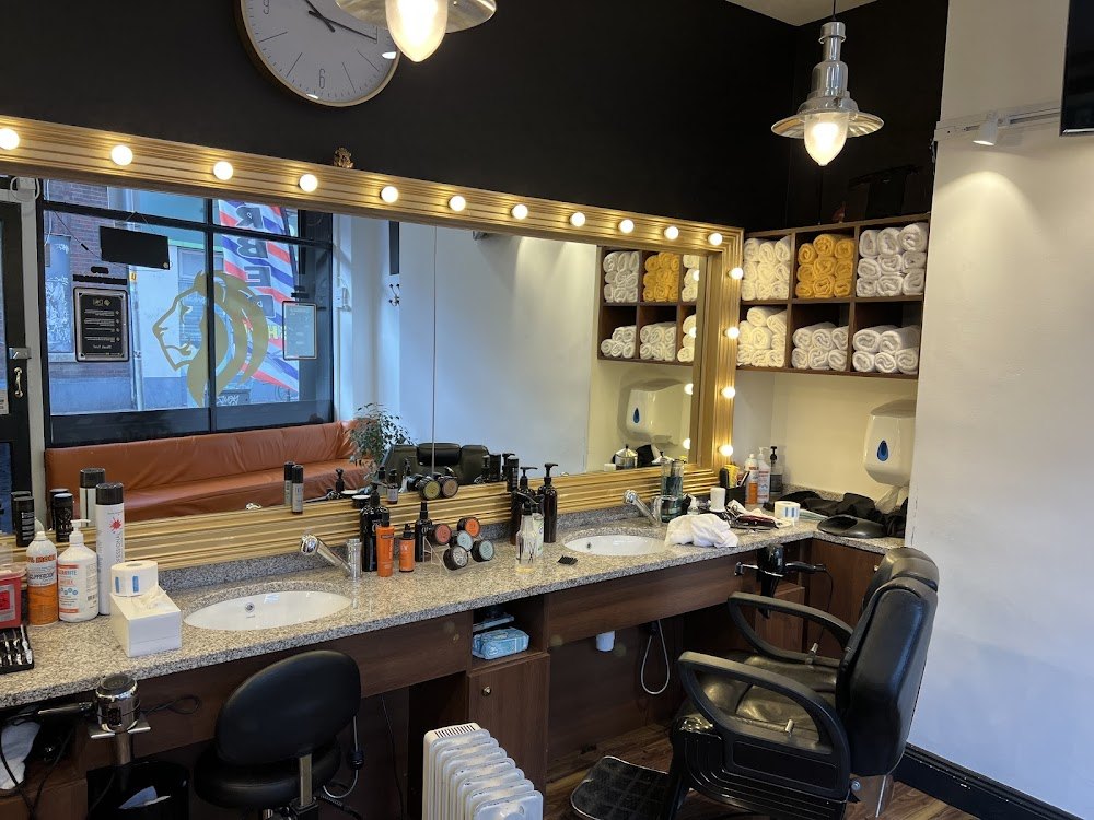 Barber station with gold-framed mirror, granite sinks and chairs inside D&J Barbers, Temple Bar